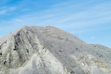 A large pile of rubble for road construction. Crushed stone for concrete mix. large piles of crushed granite or gravel in the concrete industryの写真素材