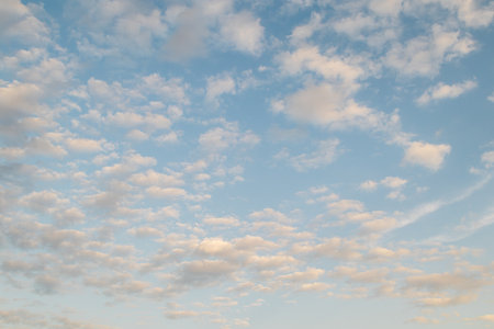 Beautiful deep clearly blue sky with white a little puffy clouds in a sunny day, soft focus
