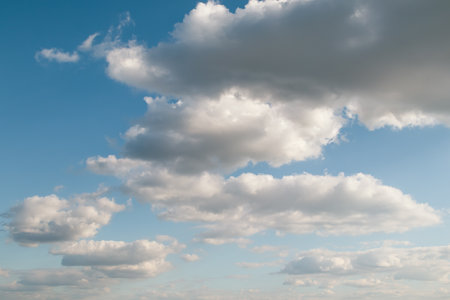 White clouds scattered across the blue sky. Landscape photography for design and print. Nature and weather conceptの写真素材