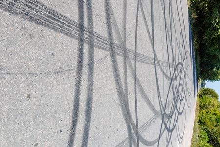 skid marks on a road surface. Circular tire marks left by drivers doing donuts.の写真素材