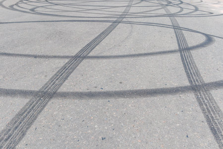 Tire track mark on asphalt tarmac road texture and backgroundの写真素材