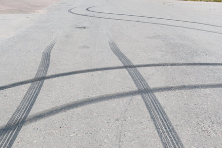 Black traces of car braking on the asphalt. Close-up of skid marks on the roadの写真素材