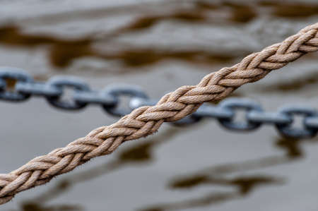 Rope and chain. Blurred background, selective focus.の写真素材
