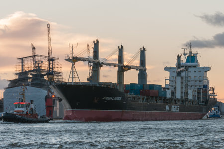 Hamburg, Germany - 01. December 2013: Freighter Amber Lagoon, since 2017 named Magnolia, 4 cranes midship, arrives in Hamburg in the evening.のeditorial素材