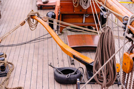 View on upper deck of sailing ship with tiller at daylight.の写真素材