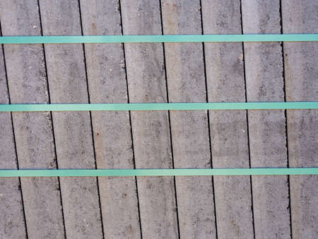 Concrete paving slabs bundled and secured with plastic strap on Euro palett.