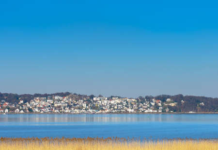 View from southern banks of Elbe River at Blankenese village at fine weather and reed belt in...