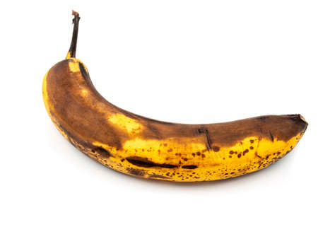 One overripe banana with yellow brown peel from above isolated on white background. Selective focus.の写真素材
