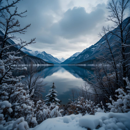 Beautiful winter landscape with snow covered mountains and lake. Long exposure.の素材