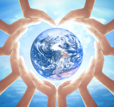 prevent corona virus concept: Heart shape of hands holding earth globe over blurred nature...