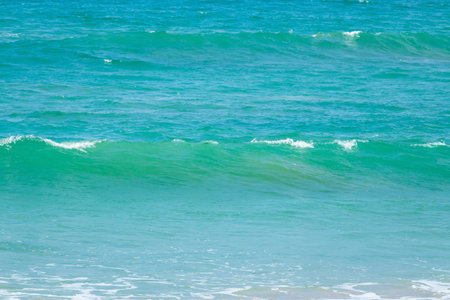 Breaking sea wave on a sandy beach backgroundの写真素材