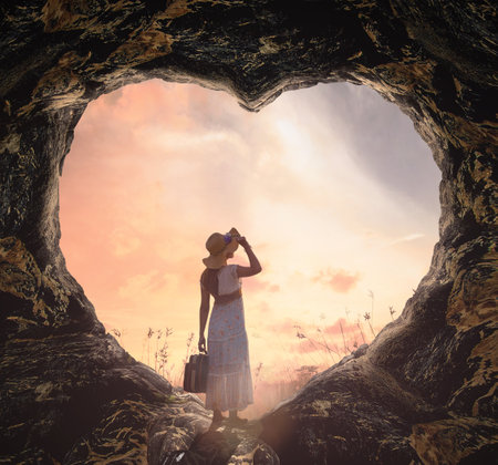 International human rights day concept: Silhouette alone woman standing on cave of heart and meadow sunset backgroundの写真素材