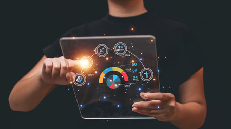 Businesswomen holding a tablet with business graph and chart on the screenの写真素材