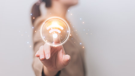 Businesswoman on blurred background using digital 3D rendering wifi connection interfaceの写真素材