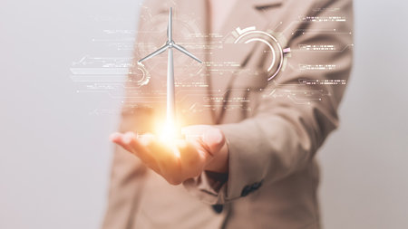 Close up of businesswoman holding wind turbine with energy formula on screenの写真素材