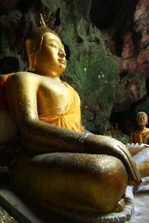  golden image of Buddha is sitting in a cave, Khao Luangのeditorial素材