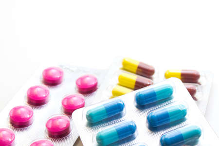 closeup colorful capsules and pills isolated on white backgroundの写真素材