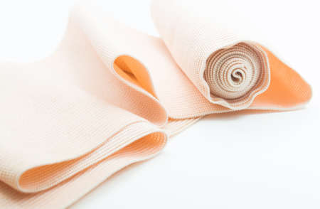 Roll of medical elastic bandage roll in isolated white backgroundの写真素材