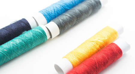 the white background of the coils with colorful thread spools