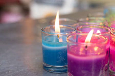 colorful burning candle in glassesの写真素材