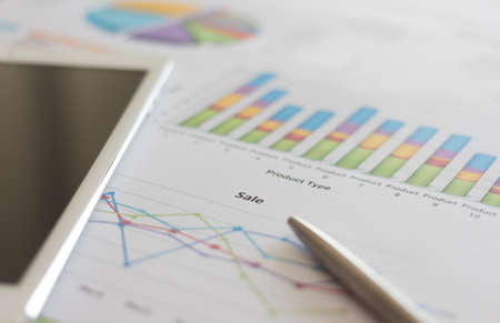 sale planning by product type report with black screen tablet and penの写真素材