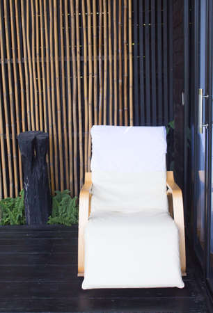 white wooden sun bed chair in front of roomの写真素材