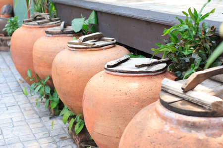 aged water earthen jar in the garden