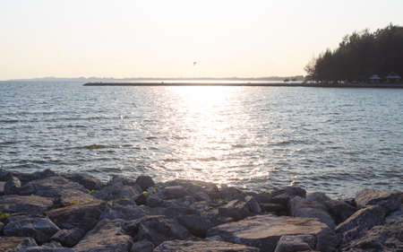 rough rocks and wave surface with sunsetの写真素材