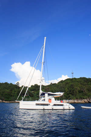 sailing boat in clear water sea  at Tropical white bay beach