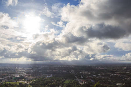 aerial top view of urban city with clouds and sun light reflectの写真素材