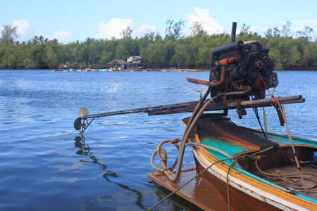 long tail boat motor engine in tranquil sea  in fisherman village ,Trang Thailandの写真素材