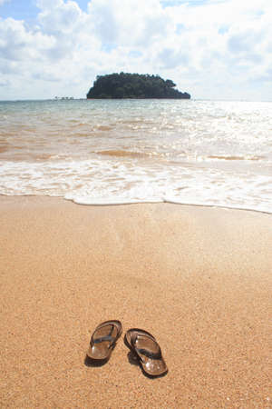 flip flops sandals on sand beach in relax and vacation summer timeの写真素材