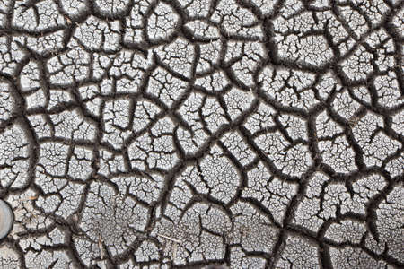 dry earth and cracked ground texture, broken split land with soil backgroundの写真素材
