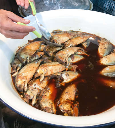 arranged boiled mackerel sauce soup in  stainless display in the marketの写真素材
