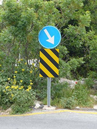 Road sign traffic obstruction on the rightの写真素材