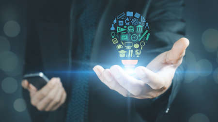 concept of education .A business man holding a study idea in his hand.