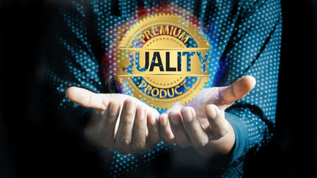 Quality product symbol in the hand of a business man.Hand shows the sign of the top service Quality...
