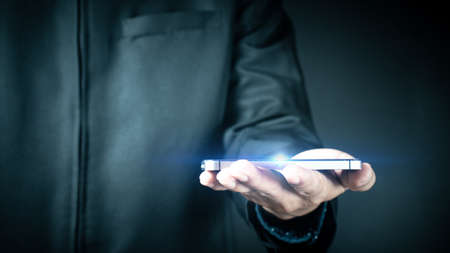 Businessman holds smartphone business internet tecnology conceptの写真素材