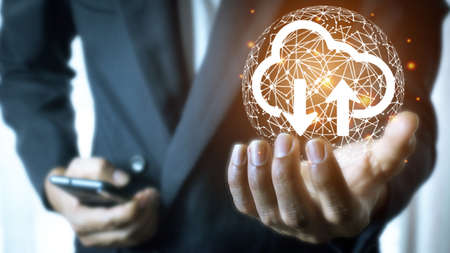 Businessman hold cloud icon.Cloud computing concept - connect smart phone to cloud. computing network information technologist with smart phone.Big data Conceptの写真素材