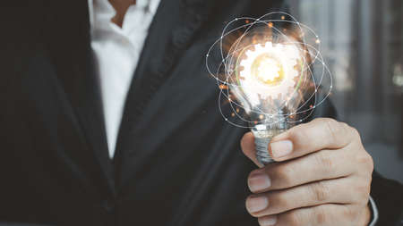 Businessman holding a light bulb, new ideas with innovative technology and creativity.creative idea...