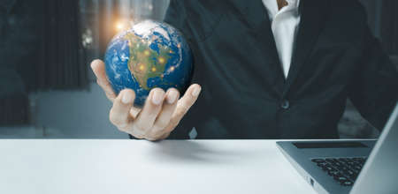 Hand of a man holding flying the earth, Energy and ecology concept