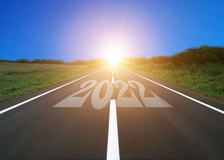 Start new year with fresh vision and ideas. 2022 numbers on asphalt road
