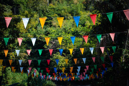 Many multicolored triangular flags adorn the blurred garden. , postcard background, Valentine's Dayの写真素材