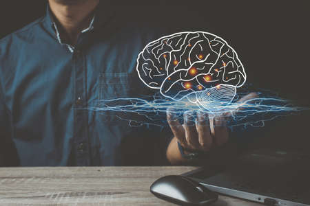 Close up of businessman holding digital image of brain in palm