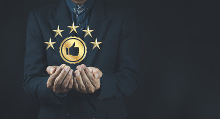 Quality product symbol in the hand of a business man.Hand shows the sign of the top service Quality...