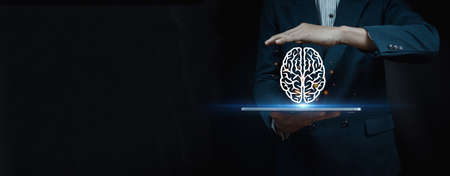 business man wearing suit holding laptop on hand with illustration of brain fair on abstract...