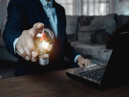 idea light bulb rocket on business man hand , business idea concept