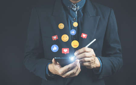 Social media and digital online concept, people use smart phone with social media. Holiday living concept and social media play Social distance, work from home concept.の写真素材