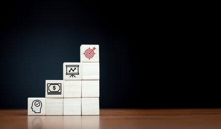 Goal board results printed on wooden cube blocks on ideas and funds icons, business information. To...