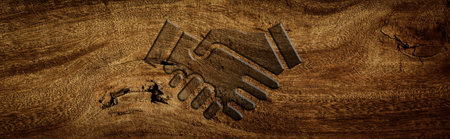 handshake symbol carved on wooden floorの写真素材